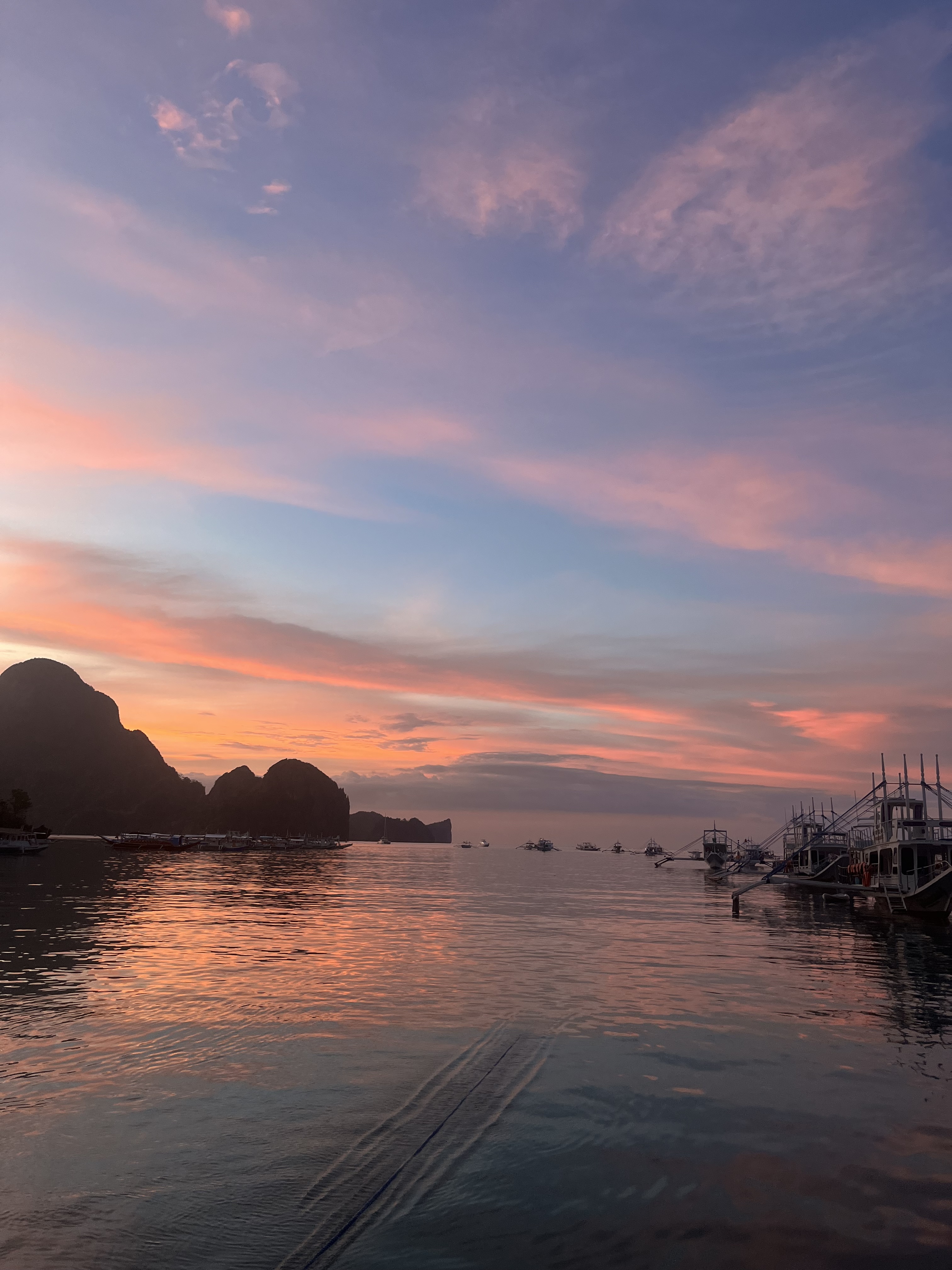 A photo of a pink and blue sunset over the water in the El Nido, Philippines.